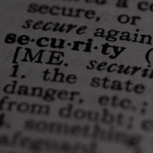 Close-up black-and-white photo of a dictionary page highlighting the word security