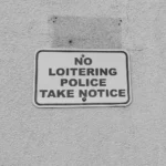 “No loitering” policy sign reflecting informal social control and CPTED principles in urban environments