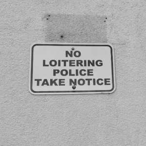 “No loitering” policy sign reflecting informal social control and CPTED principles in urban environments